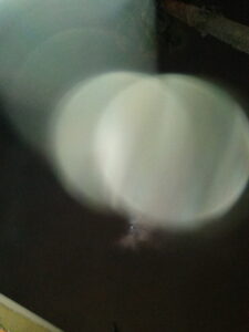 Blurry circular light reflections on dark background.