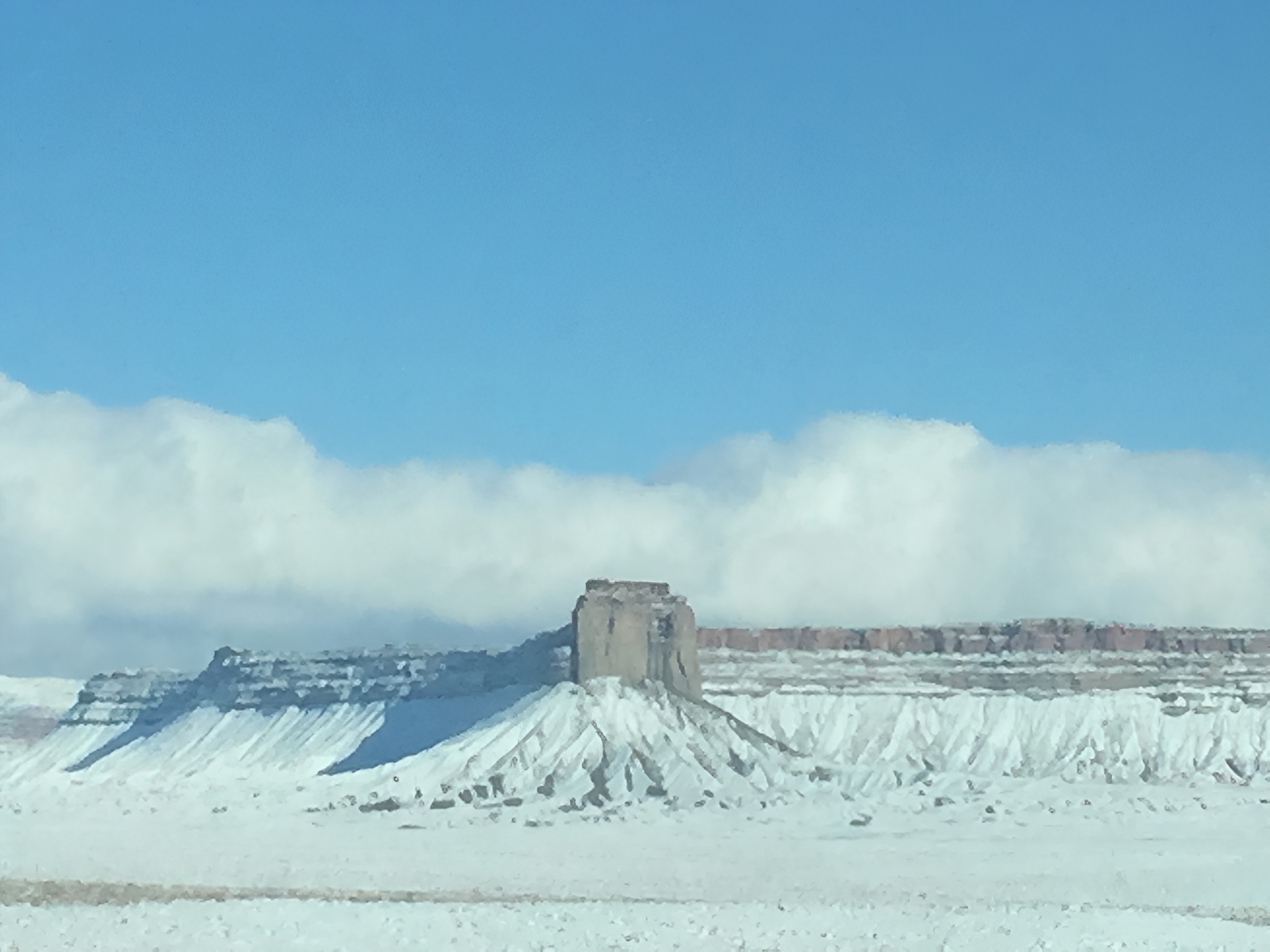 Snow-covered mesa and central flat-topped butte