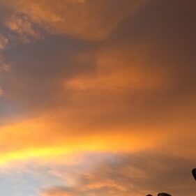 Orange and blue sunset sky with clouds.