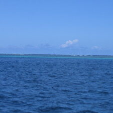 Blue ocean under clear blue sky.
