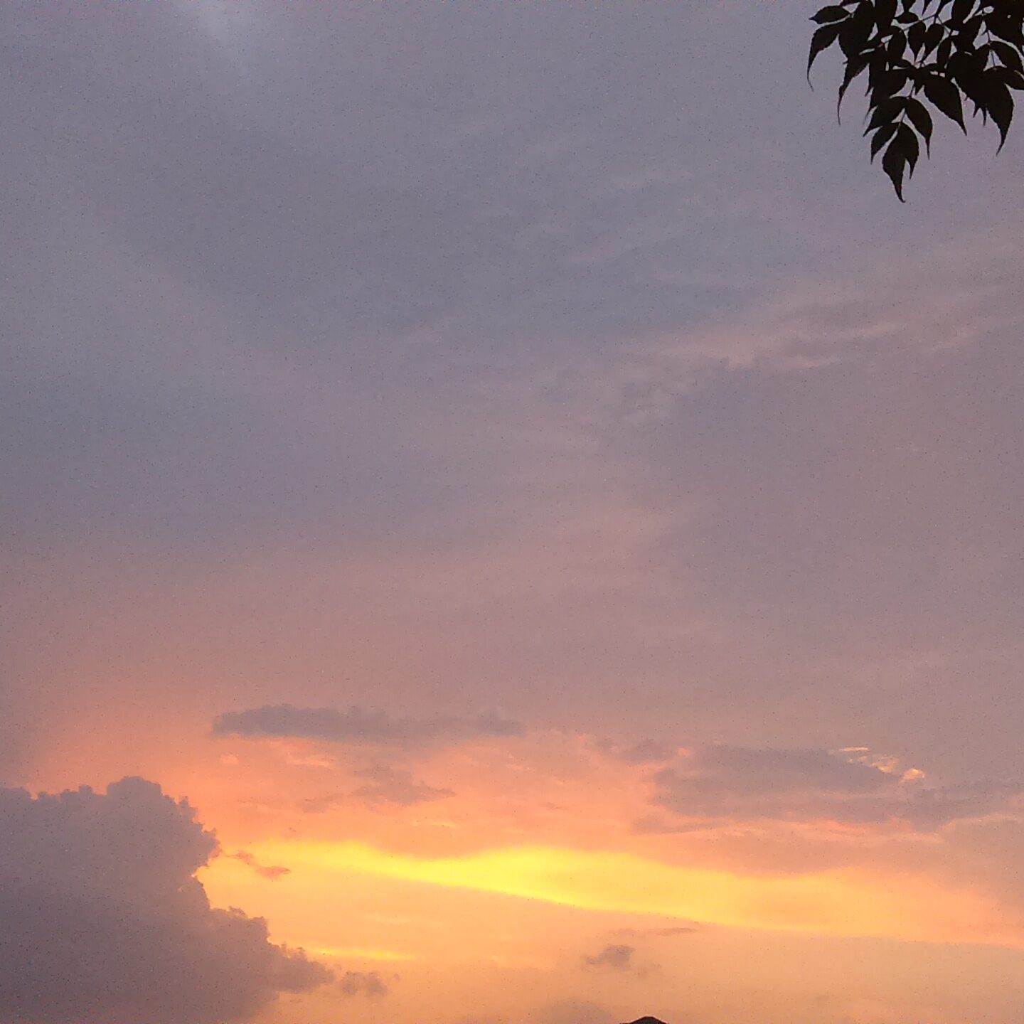Sunset sky with dark and light clouds.