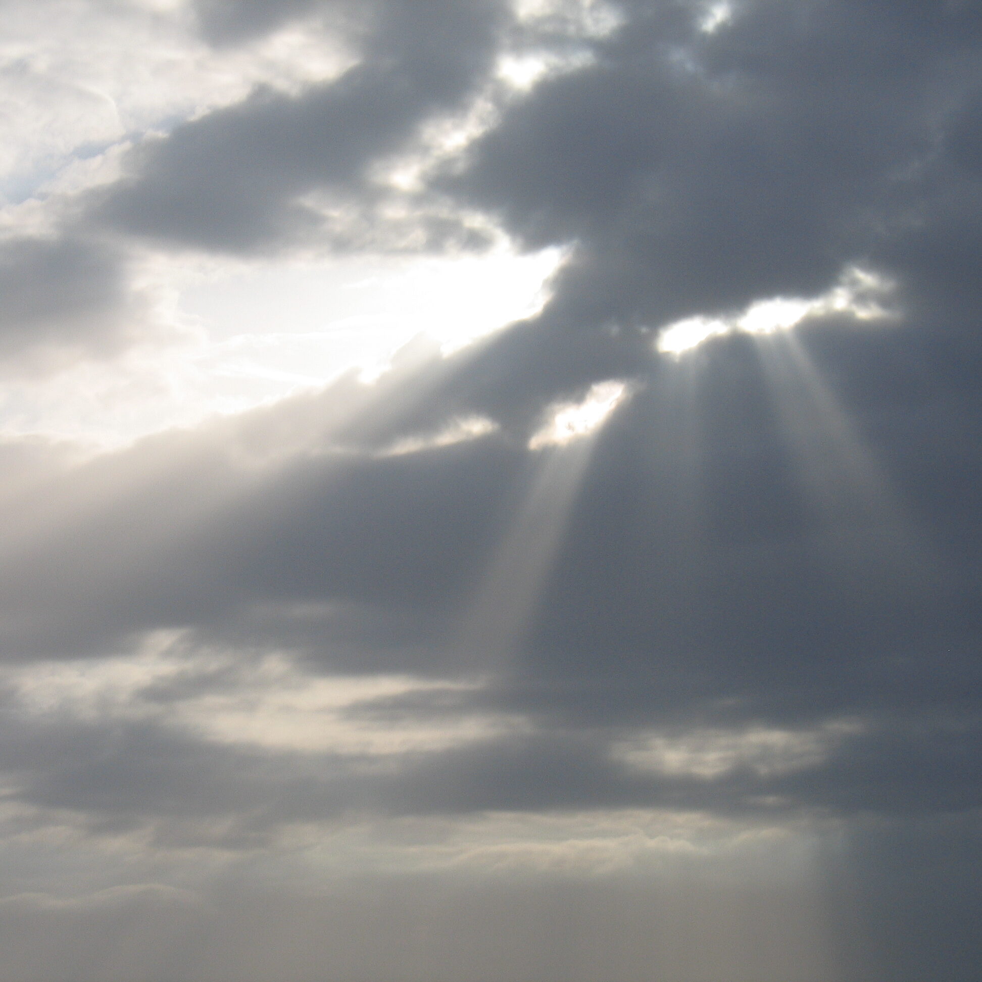 Sunlight streaming through cloudy sky.