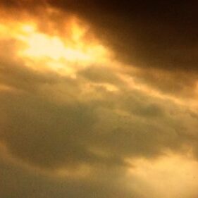 Dramatic cloudy sky with golden hues.
