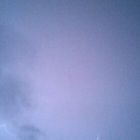 Cloudy sky with faint lightning.