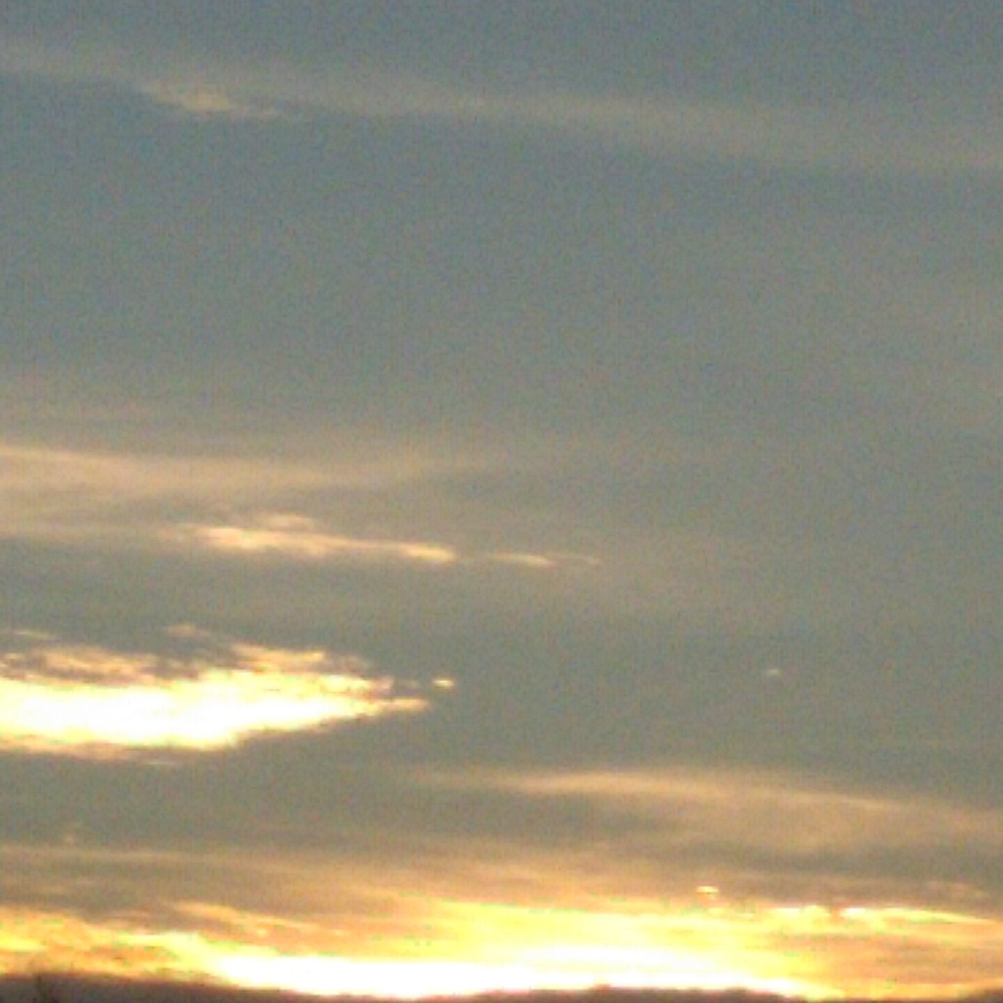 Sunset sky with scattered clouds.