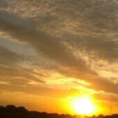 Sunset with vibrant orange and yellow sky.