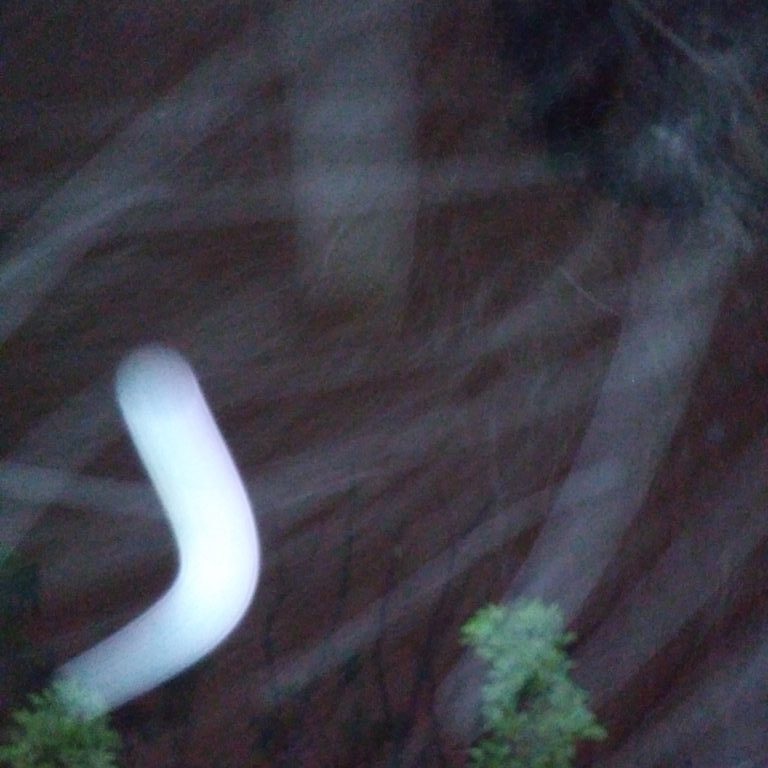 Blurred light trails over dark background.
