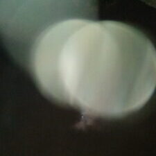 Blurry circular light reflections on dark background.
