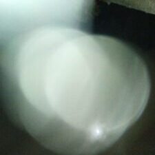 Blurry light orbs against a dark background.