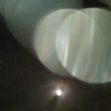 Blurry light circles with dark background.