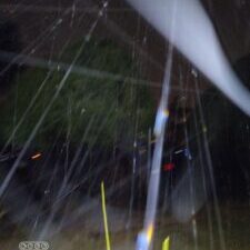 Rainy night with blurred light streaks.