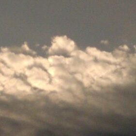Dark clouds with bright light behind them.