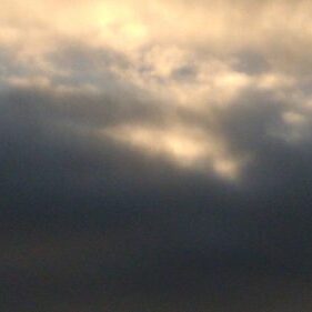 Cloudy sky with soft light breaking through.