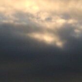 Cloudy sky with hints of sunlight.