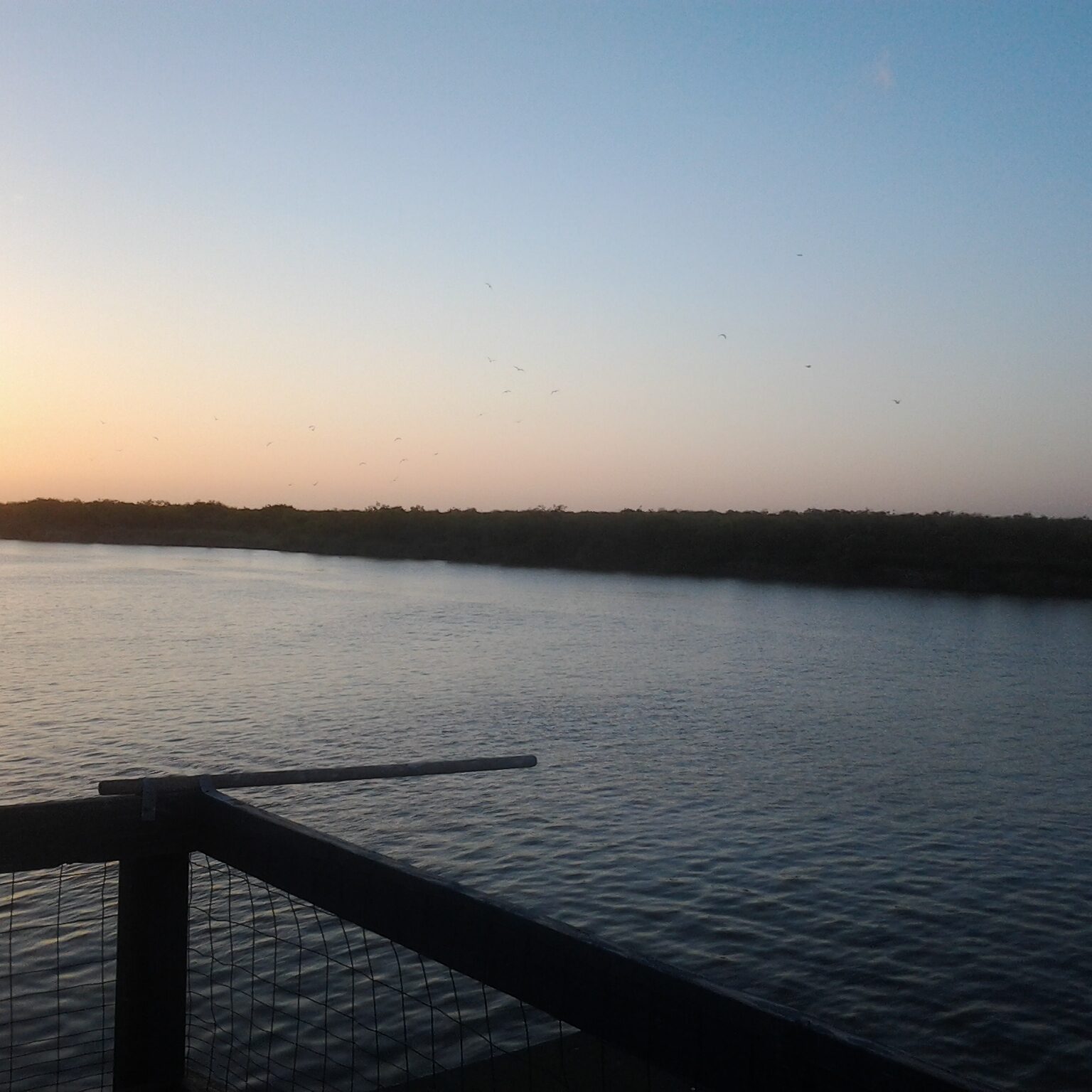 Sunset view over calm river waters.