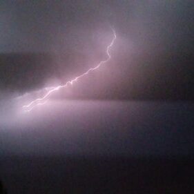 Lightning bolt in dark cloudy sky.