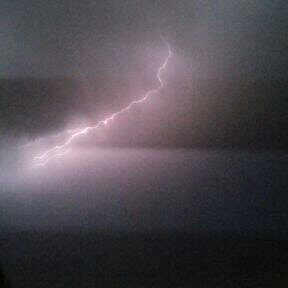 Lightning bolt in dark cloudy sky.