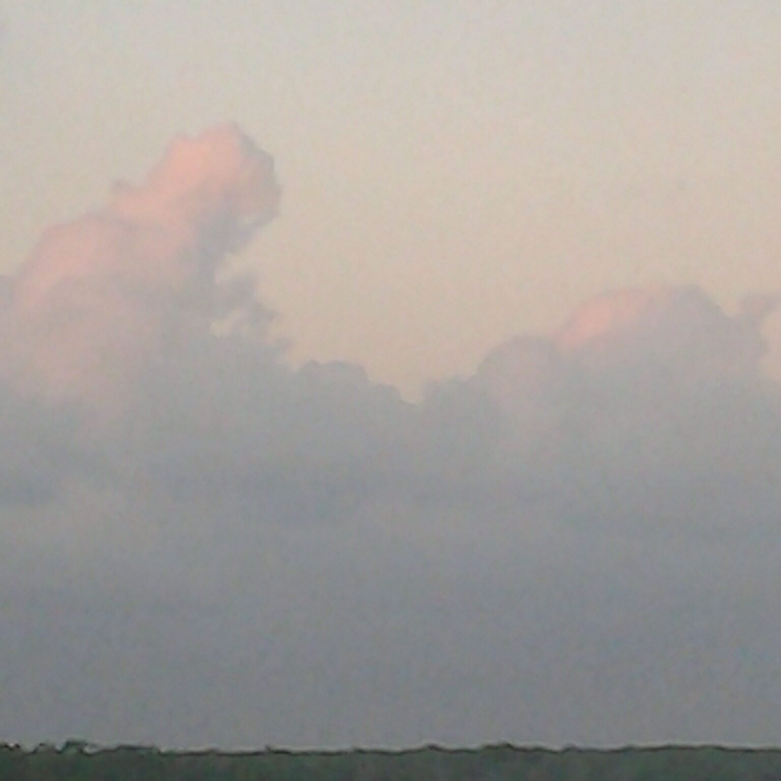 Pink clouds in a blue sky.