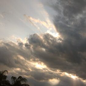 Sunlight filtering through dramatic cloudy sky.