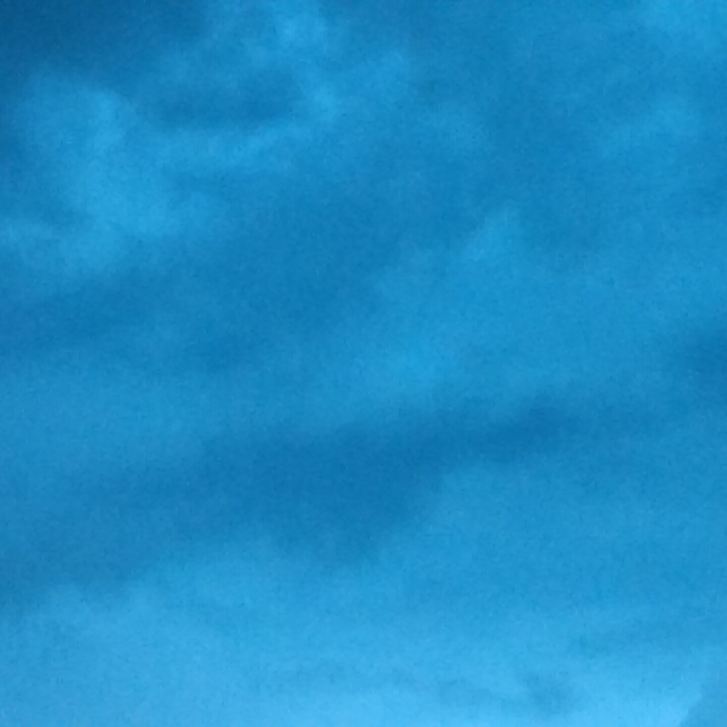 Blue cloudy sky with soft lighting.