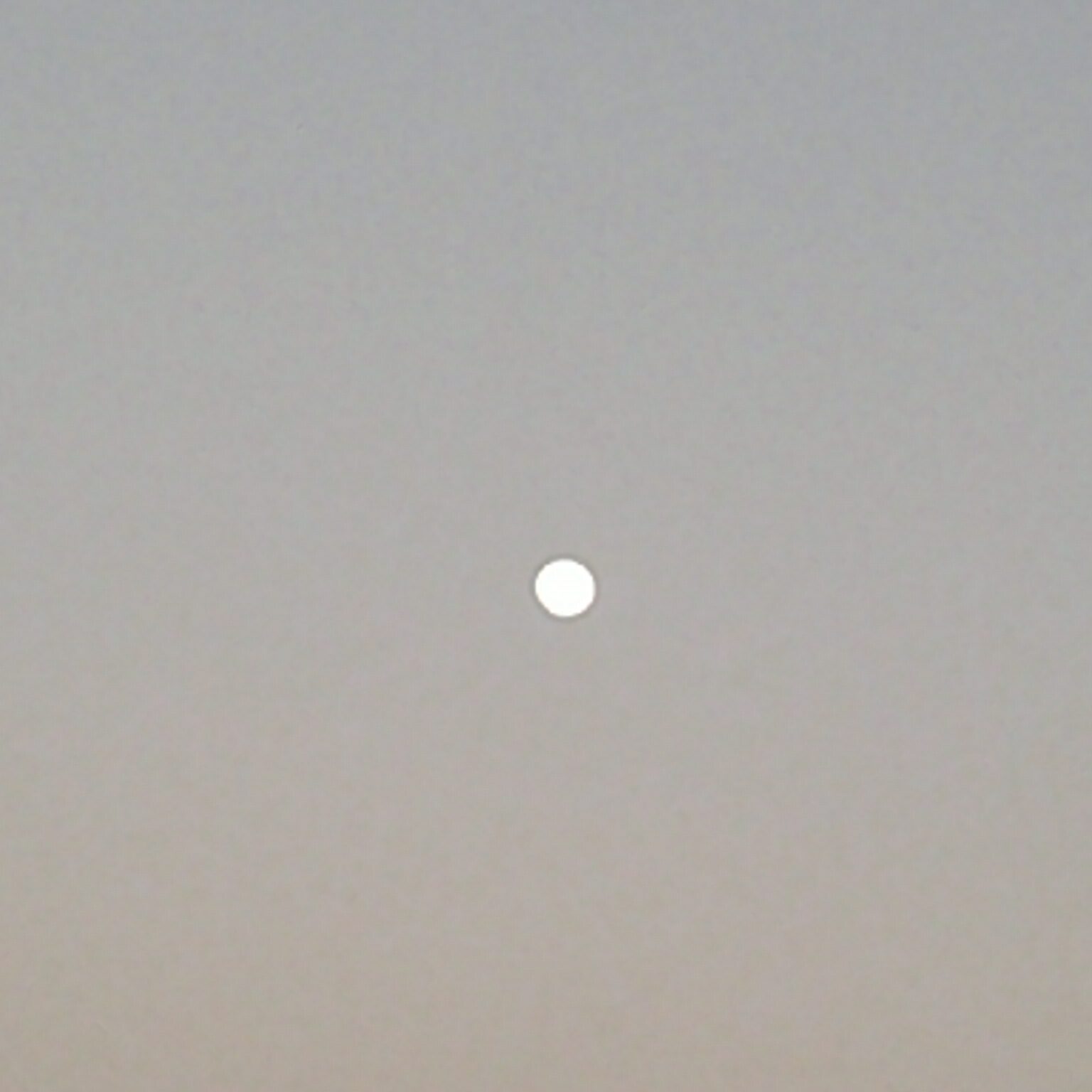 Full moon in a clear evening sky.