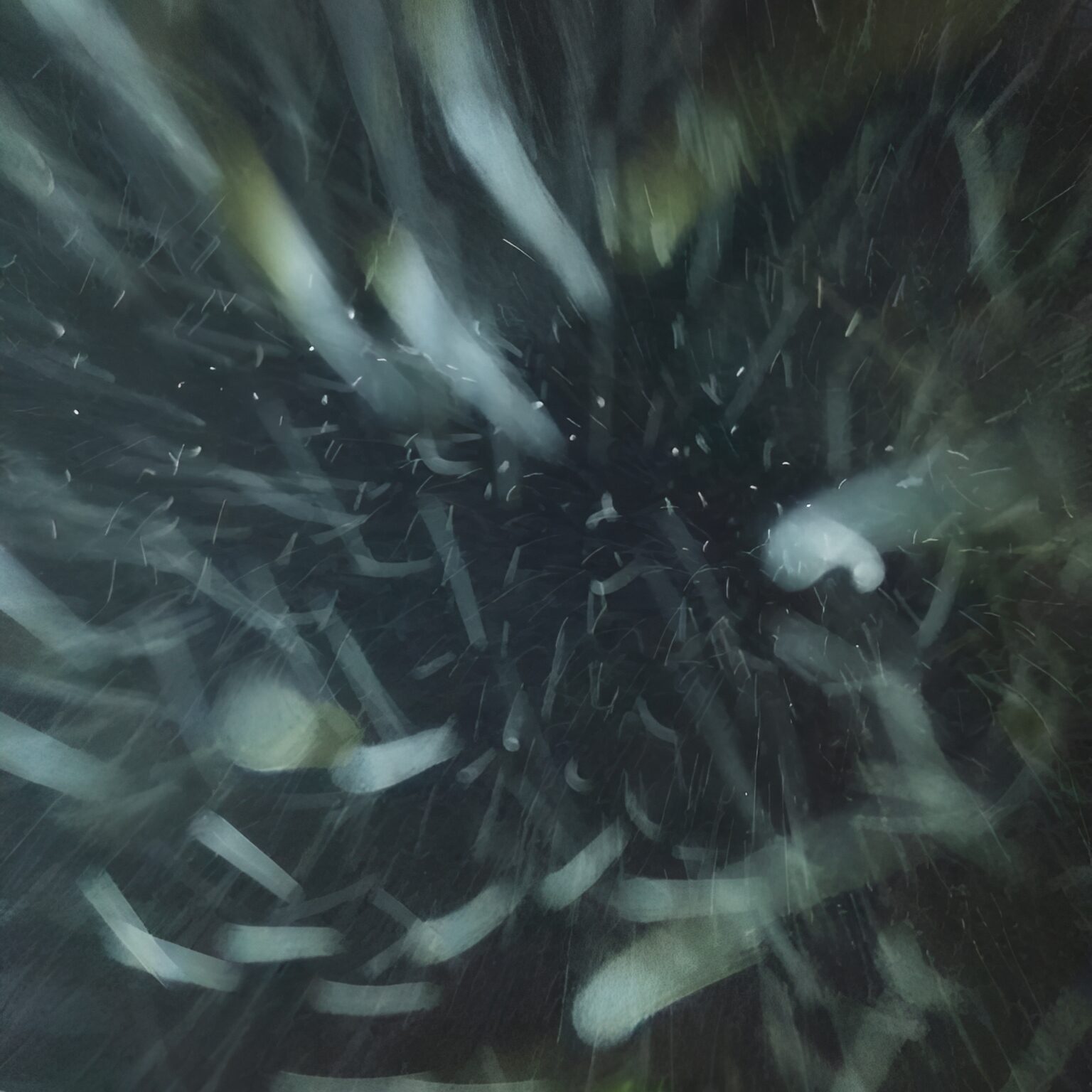 Blurry swirling snowflakes against dark background
