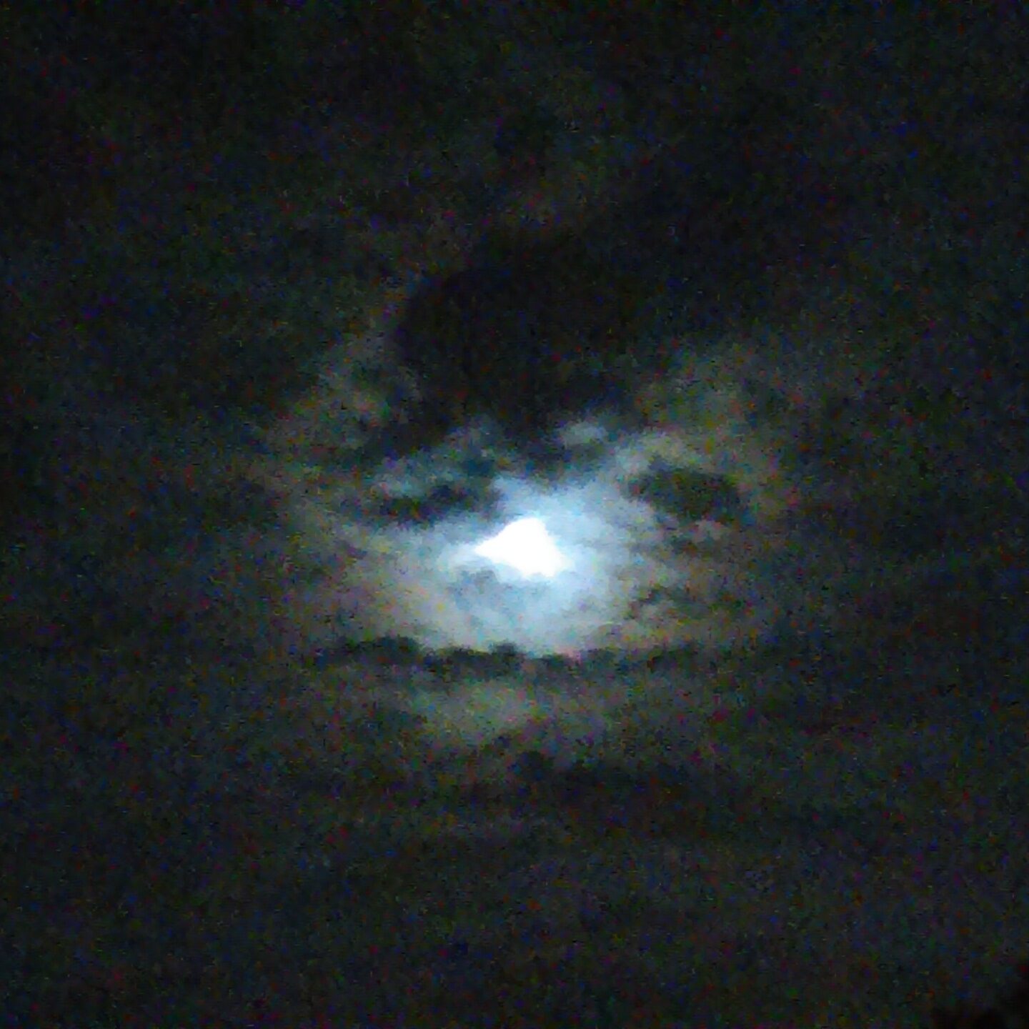 Moonlit sky with dark clouds.