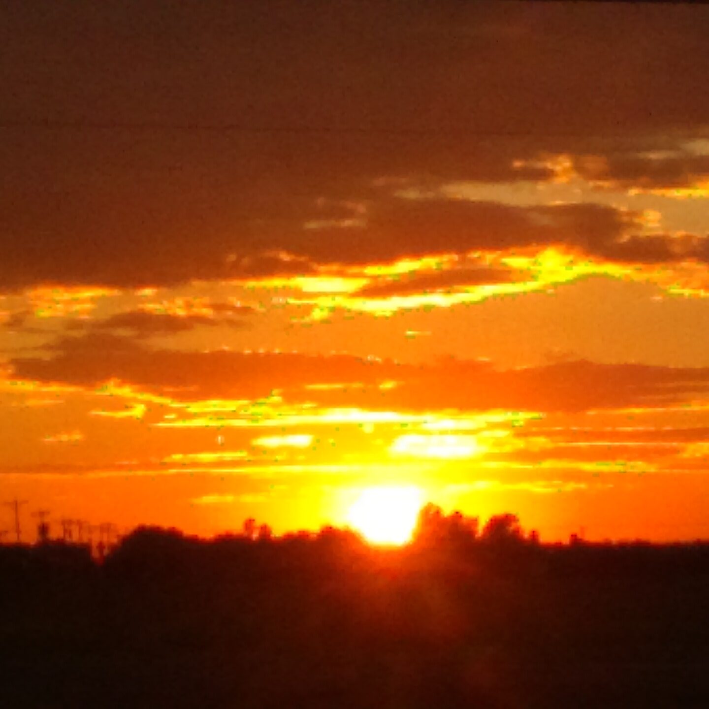 Sunset over horizon with orange clouds.