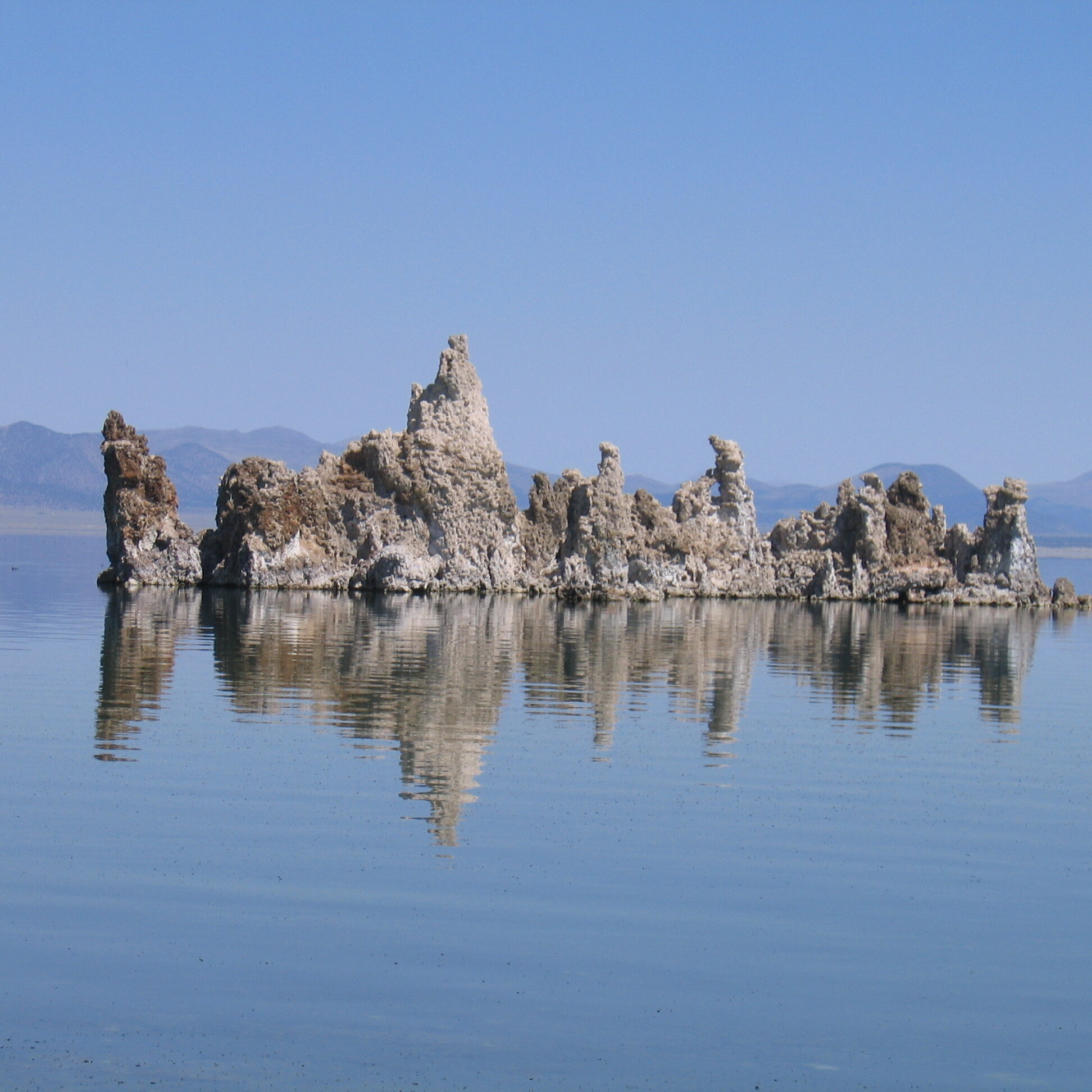 Rock formations in a calm blue lake.