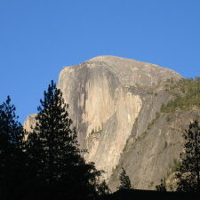 Half Dome rock formation under clear blue sky.