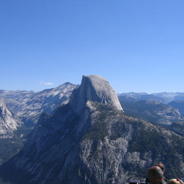 Yosemite's Half Dome under clear blue sky.