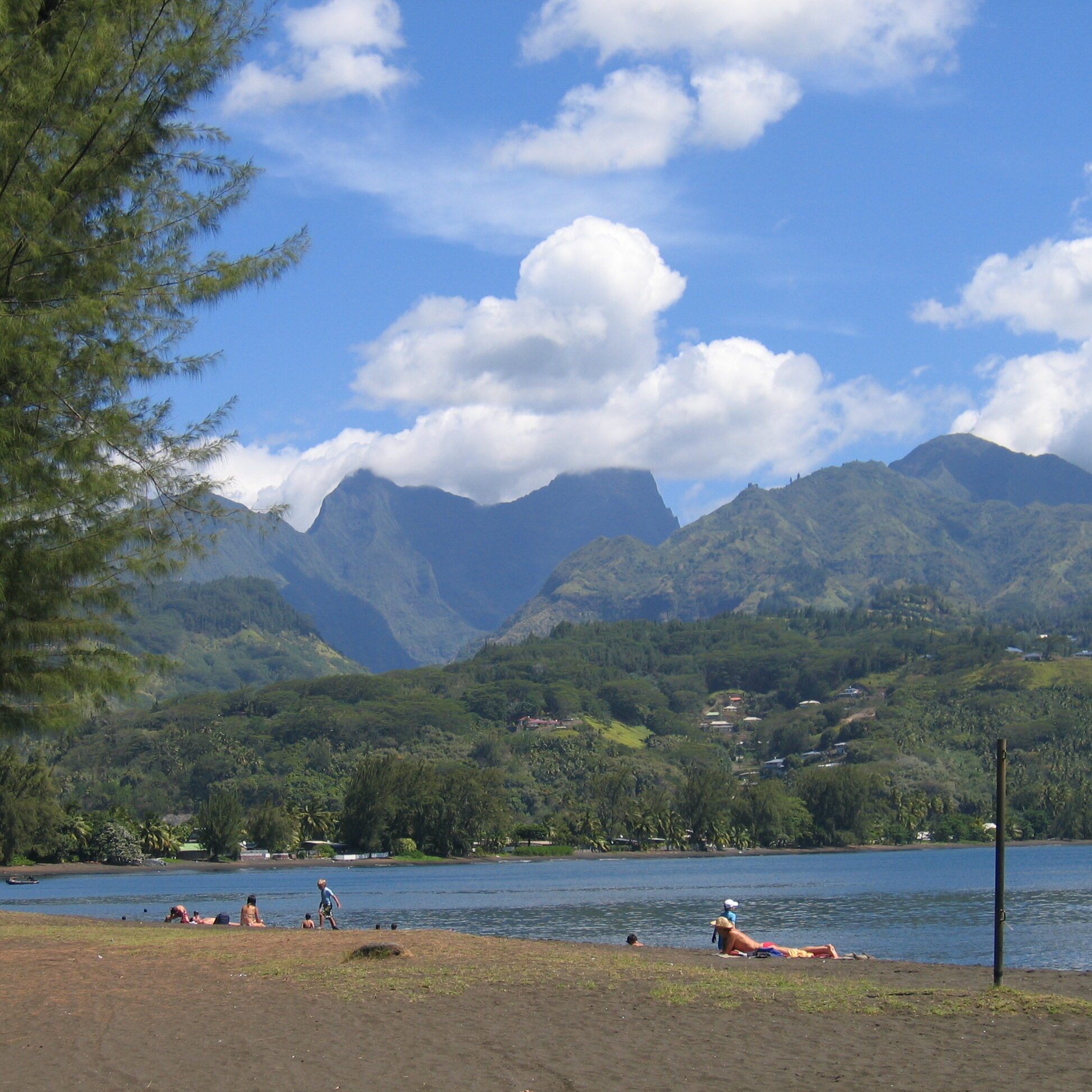 Beach with mountains and blue sky background.