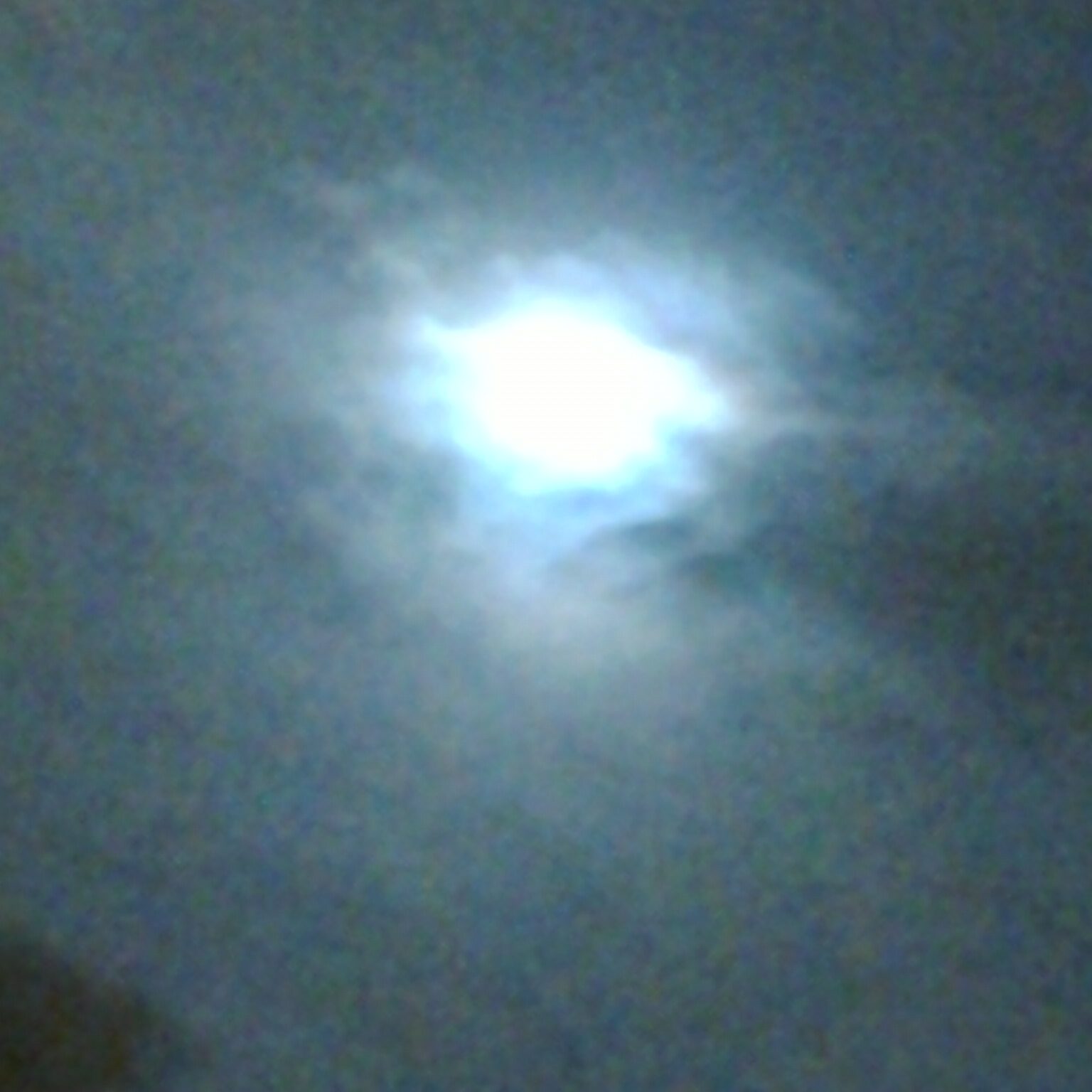 Misty night sky with bright moon.