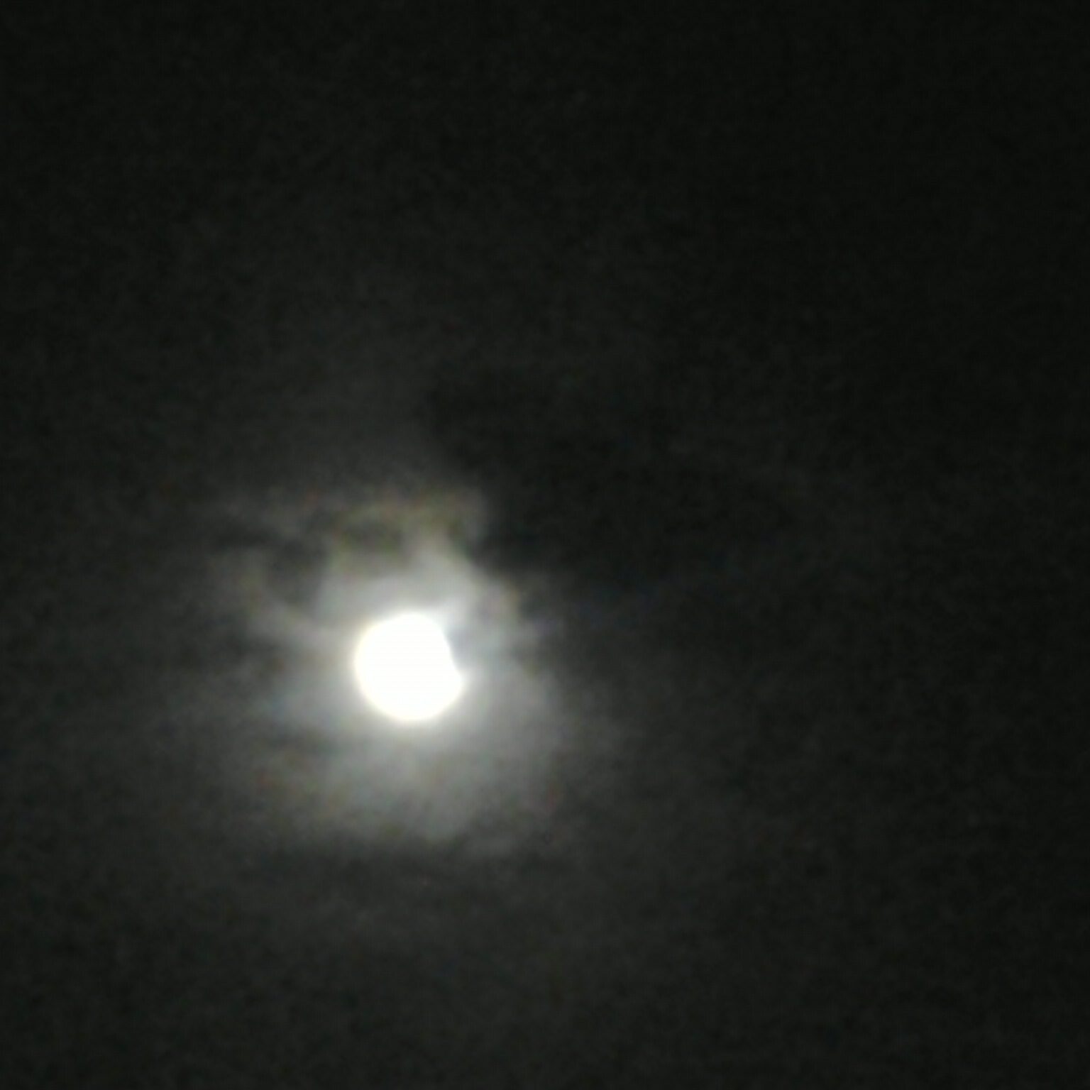 Cloudy night sky with bright moon.
