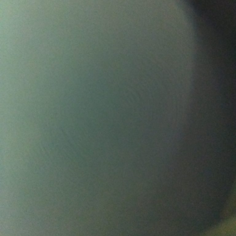 Blurry, abstract circular pattern in gray.
