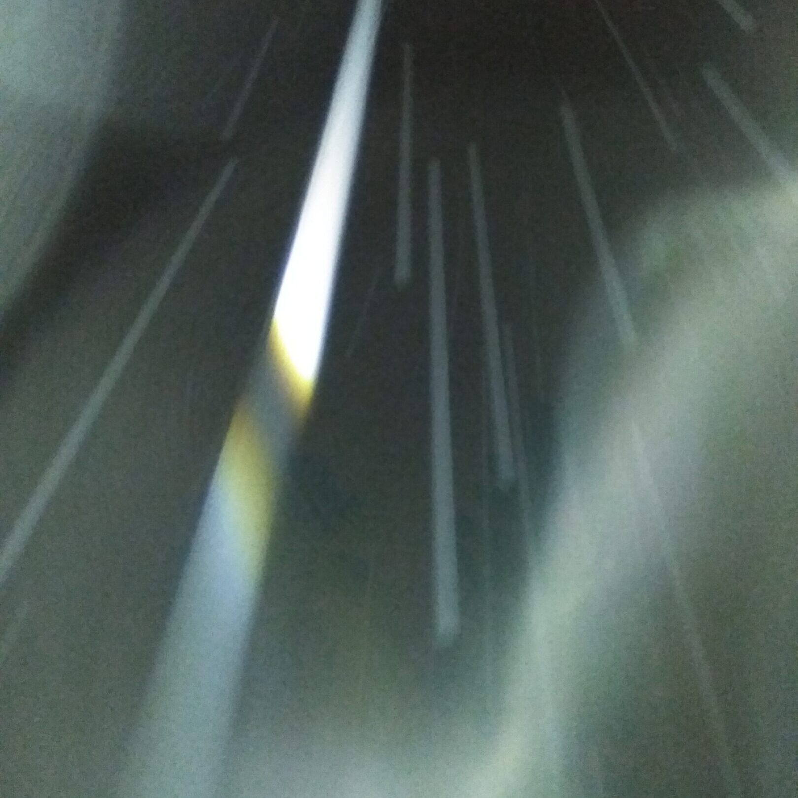 Abstract light streaks against dark background.