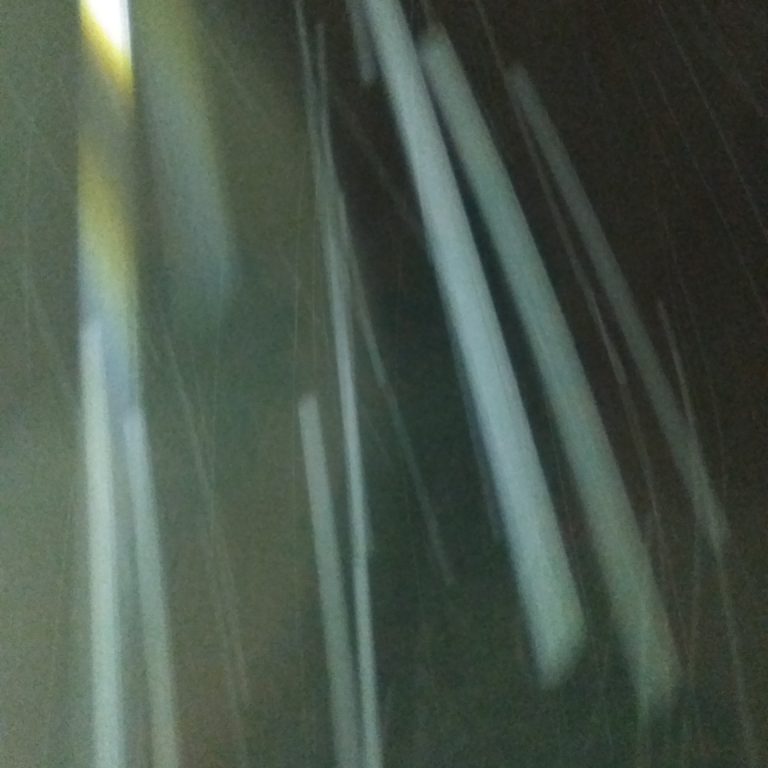 Blurry streaks of light in darkness.