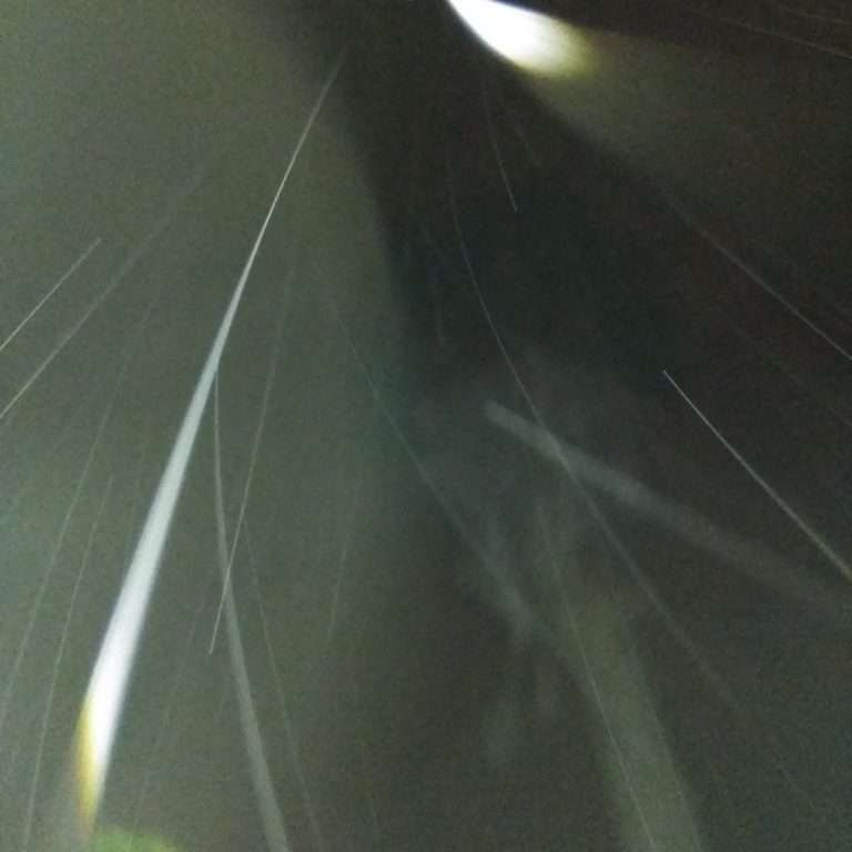 Abstract light streaks in dark sky.