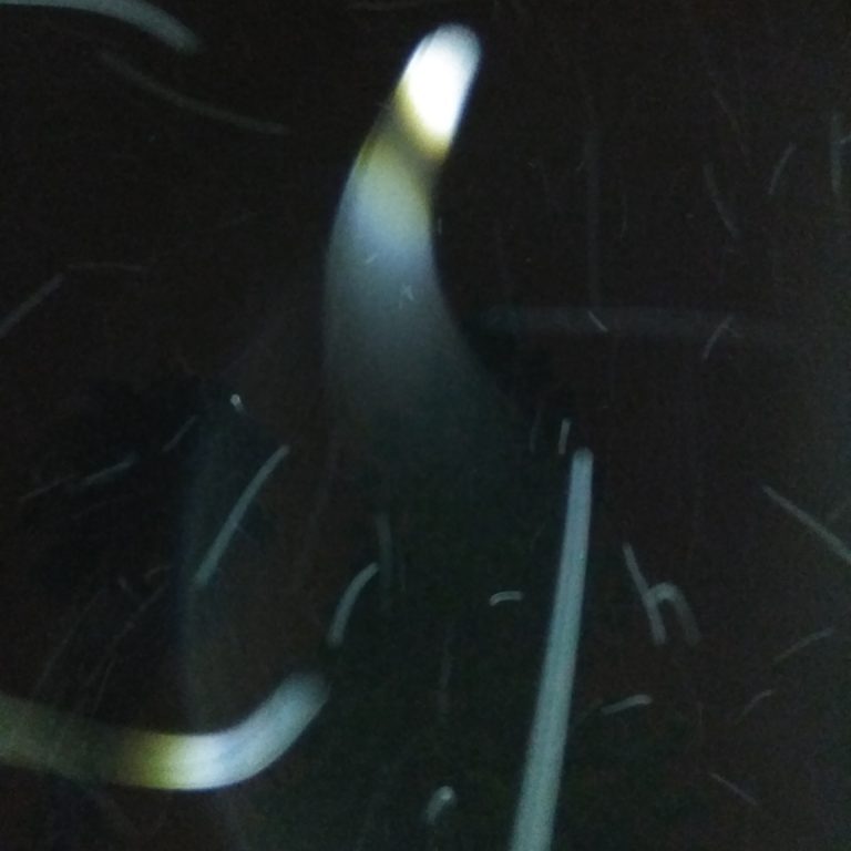 Abstract light streaks on a dark background.