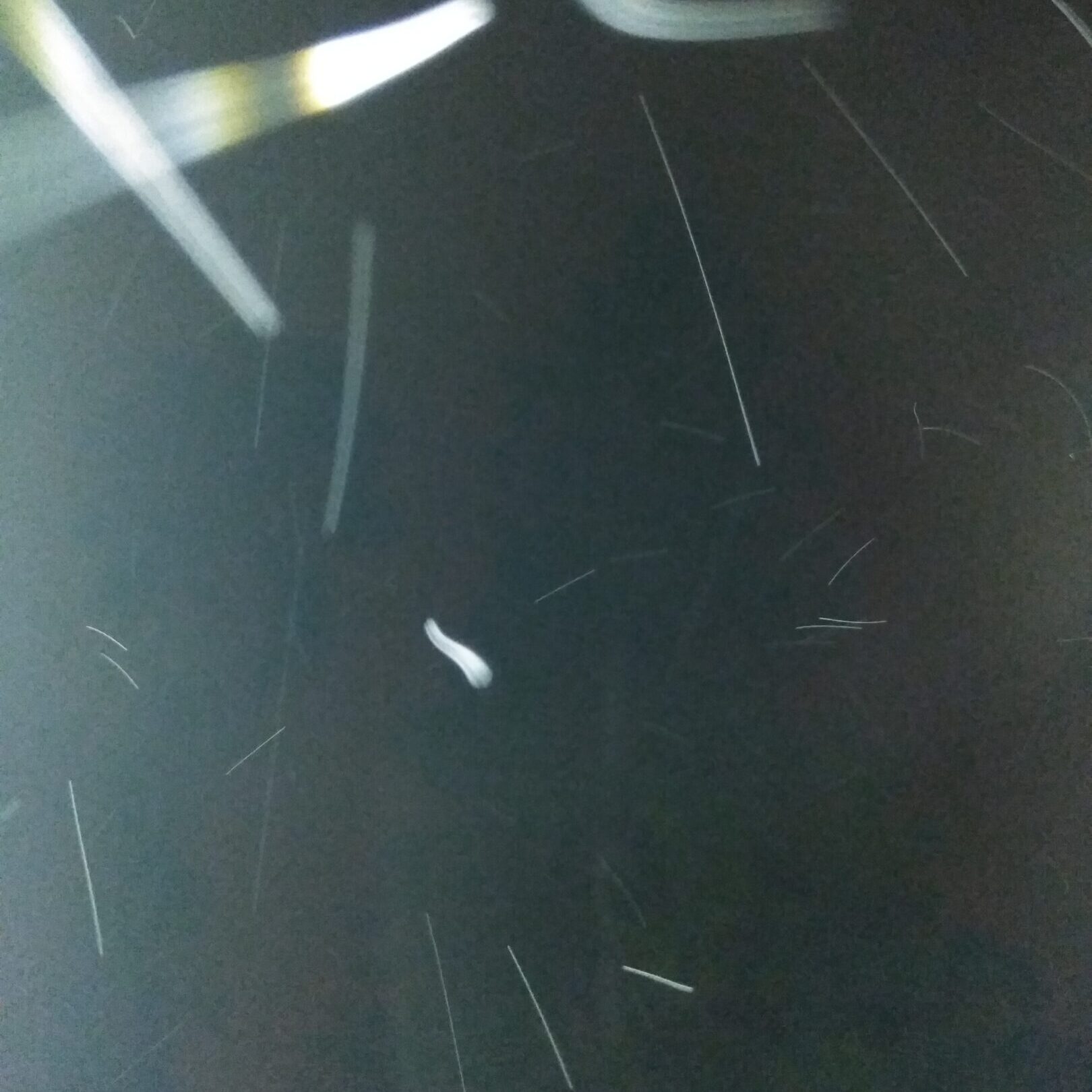 Abstract light trails on a dark background.