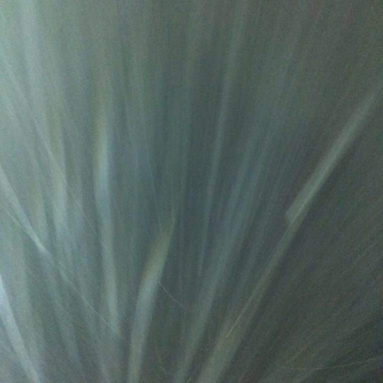 Abstract light streaks against a dark background.