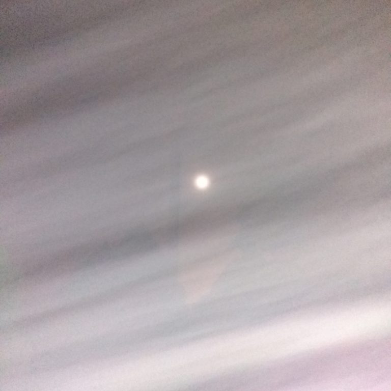 Blurry night sky with a bright spot.