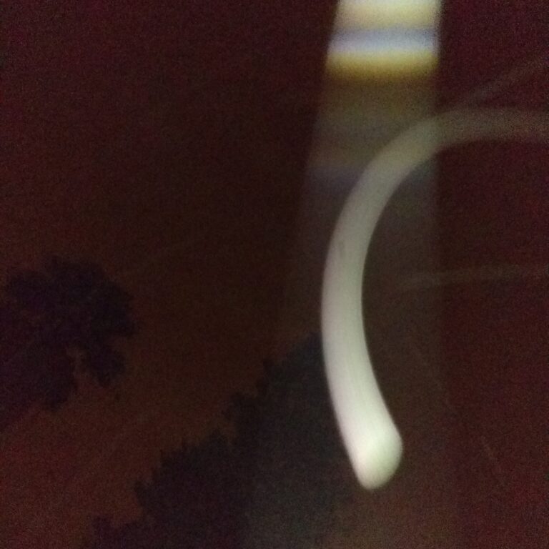 Abstract light streak in dark sky.