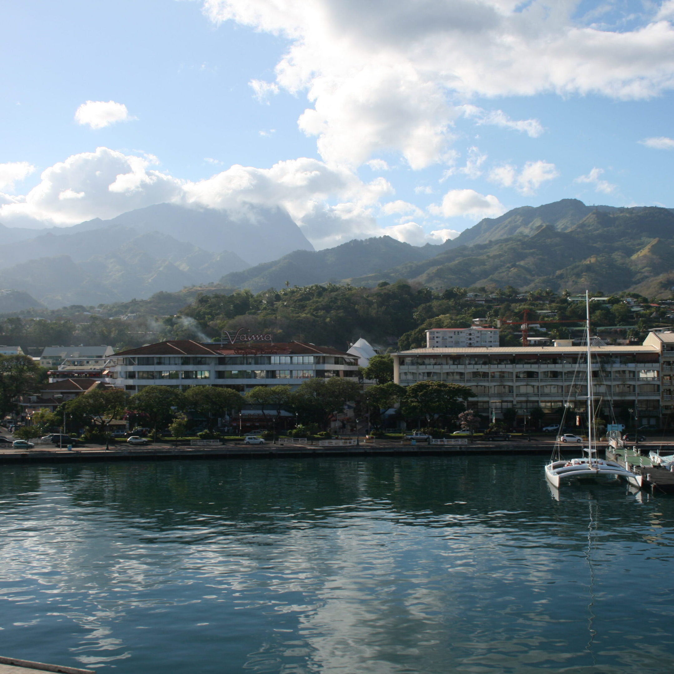 Harbor with mountains and buildings in background.