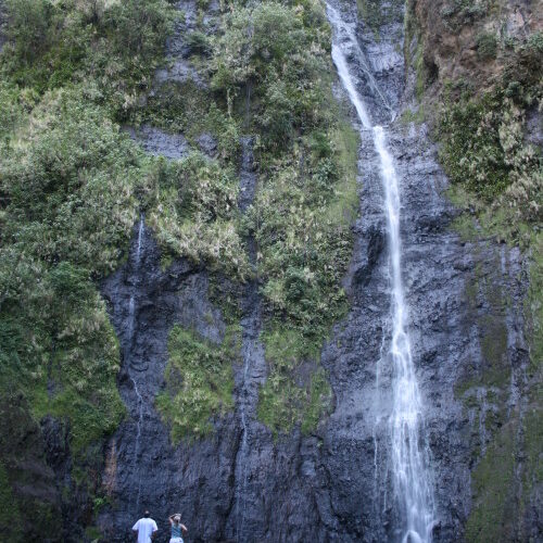 Tall waterfall cascading down a rocky cliff.