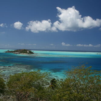 Tropical island with vibrant blue ocean waters.