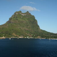 Mountain view with ocean and clear sky.
