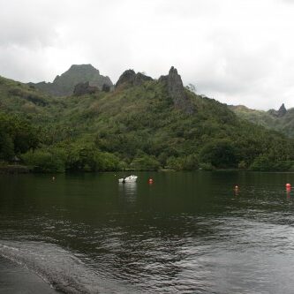 Serene lake with lush green mountains.