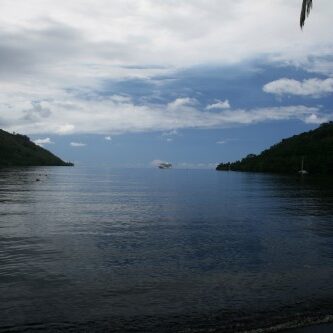 Tropical bay with lush green hills.