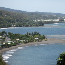 Coastal view with beach and distant hills.
